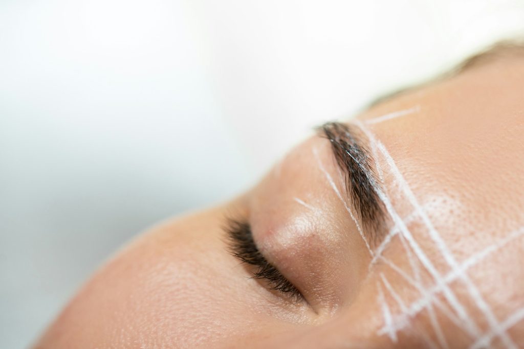 Female brow during professional eyebrow mapping procedure